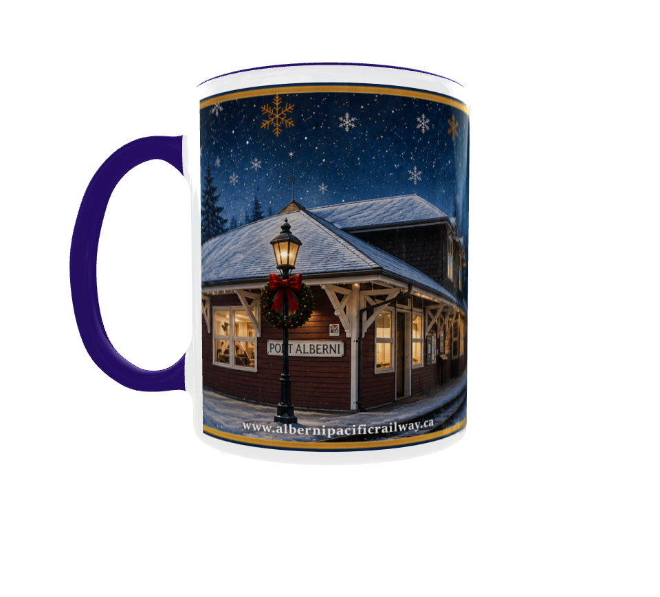 Mug with a winter scene of a lit building and snowflakes at night.